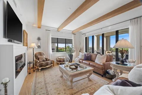 a living room with furniture fireplace and a flat screen tv
