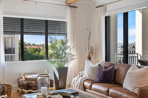 a living room with furniture and a potted plant