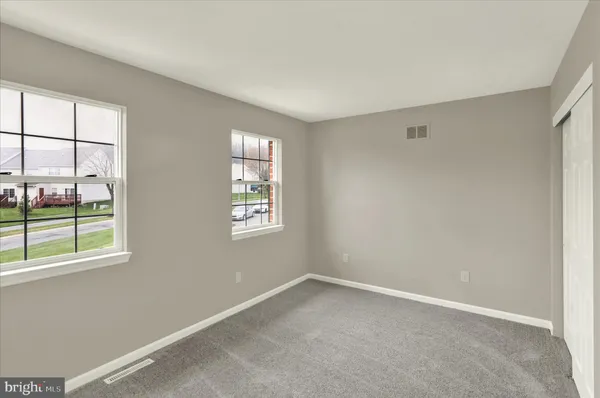 a view of an empty room with a closet