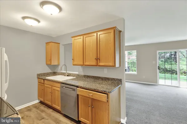 a kitchen with a granite countertop sink and window