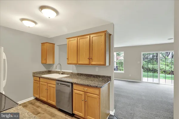 a bathroom with a granite countertop sink and a window