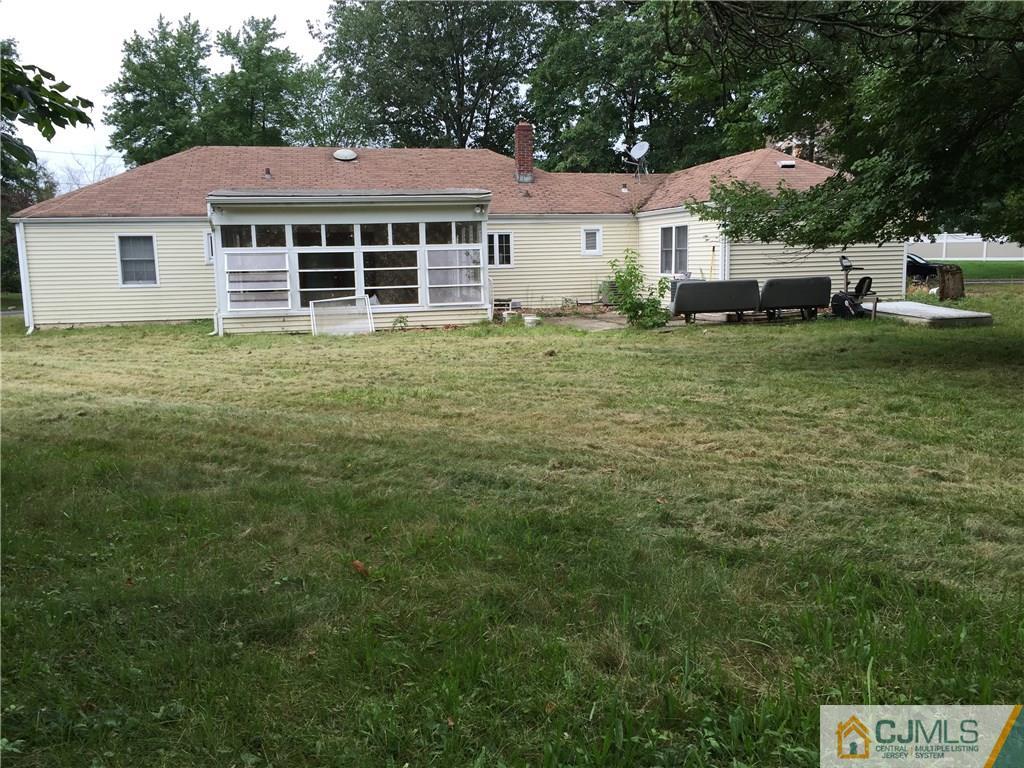 27 Richard Road Edison, NJ 08820 - Photo 4 of 5 a front view of a house with a garden