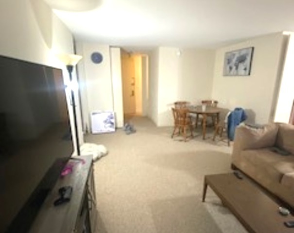 655 West Irving Park Road, Unit 1104 Chicago, IL 60613 - Photo 14 of 26 a living room with furniture and a chandelier