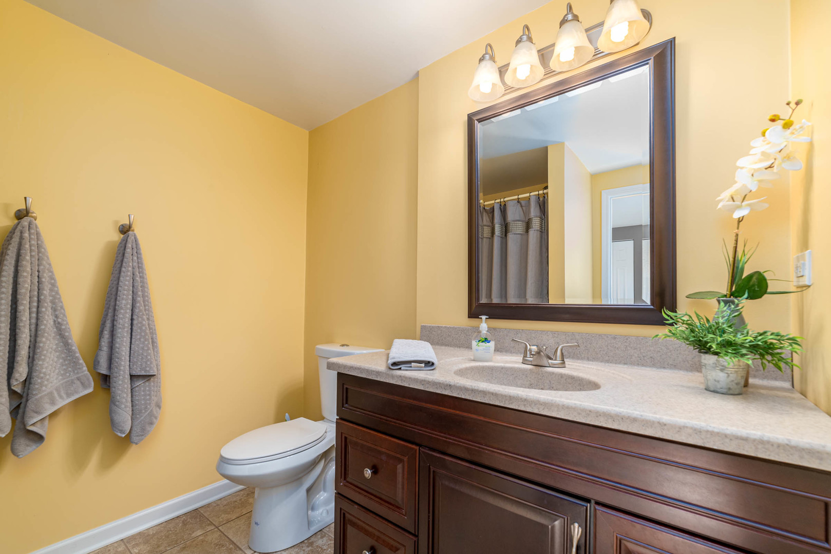 1640 Kent Road Hoffman Estates, IL 60169 - Photo 22 of 24 a bathroom with a sink a toilet and a mirror
