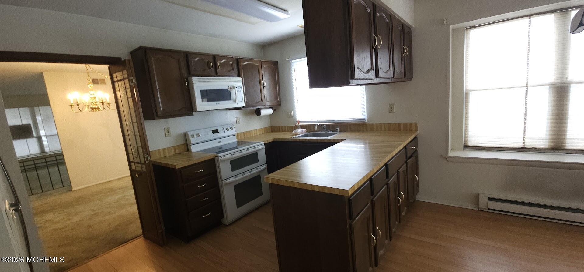29 Hastings Road Manchester Township, NJ 08759 - Photo 6 of 14 a kitchen with stainless steel appliances granite countertop a sink a stove and a refrigerator