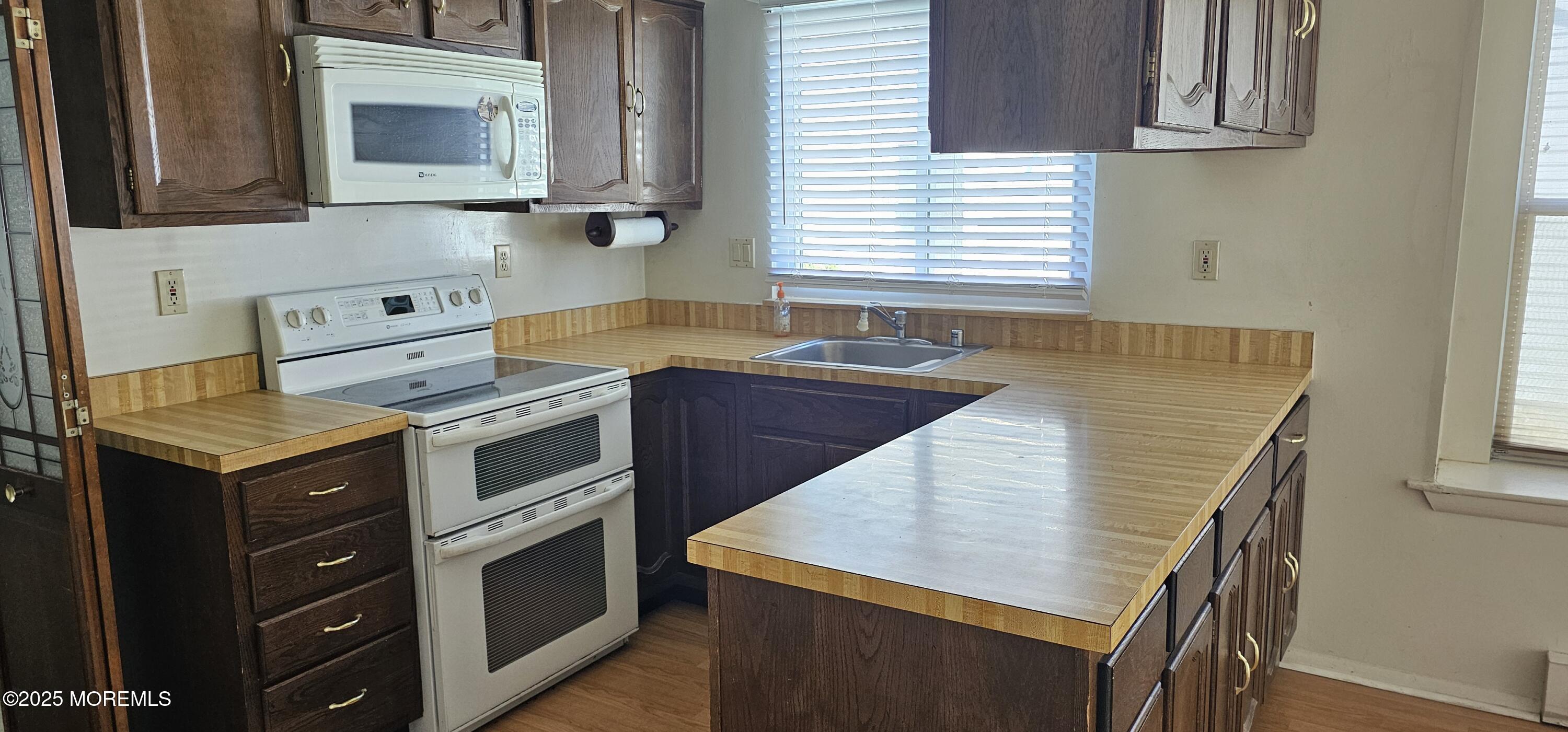29 Hastings Road Manchester Township, NJ 08759 - Photo 7 of 14 a kitchen with a stove a sink and a microwave