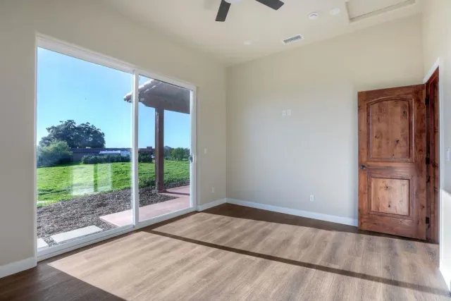 a view of a room with wooden floor