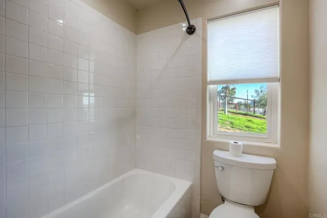 a view of a hallway with wooden floor and entryway