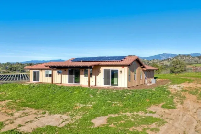 a front view of a house with a garden and yard