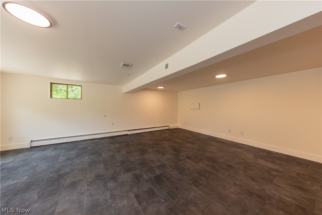 7969 Dines Road Novelty, OH 44072 - Photo 38 of 48 Spacious media room featuring wood-finish flooring, recessed lighting, a window providing natural light, and white baseboards