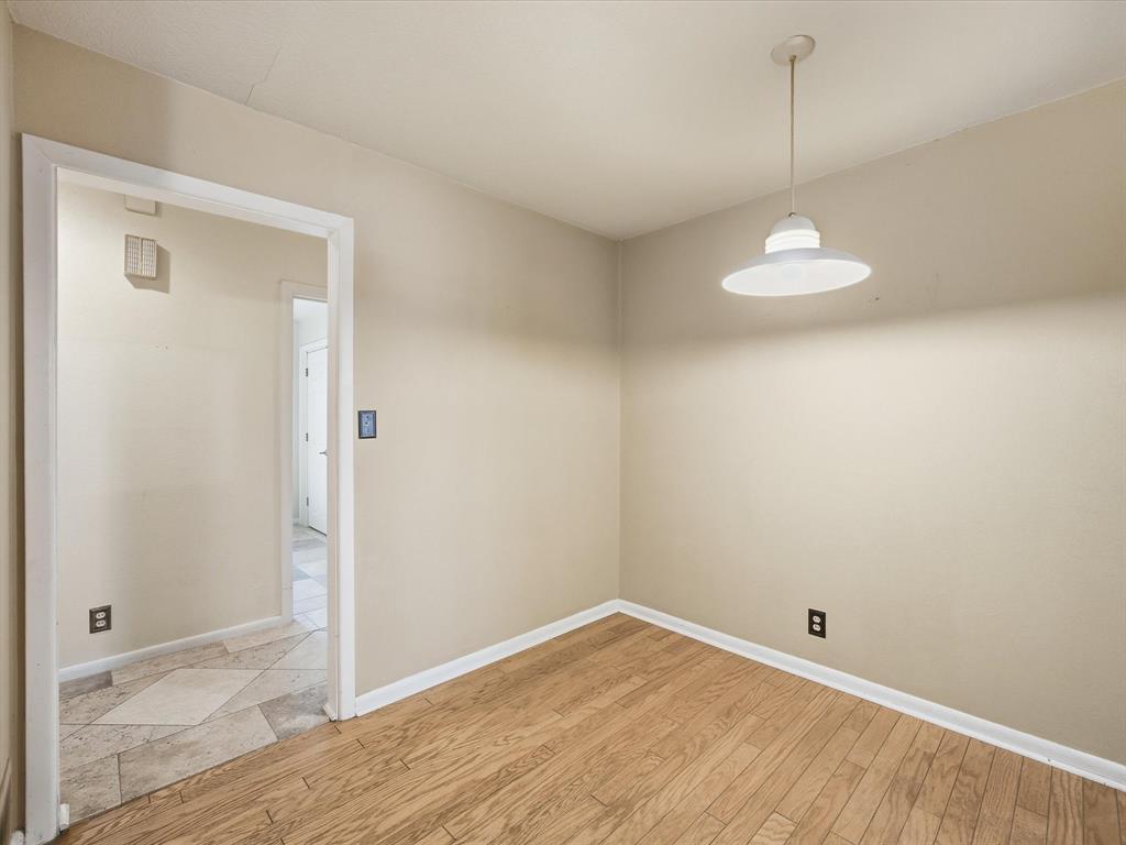 1104 Coffield Street Bowie, TX 76230 - Photo 18 of 39 a view of empty room with wooden floor