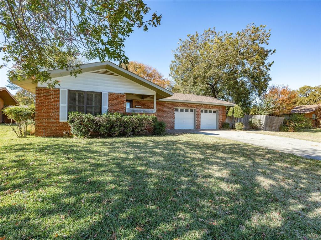 1104 Coffield Street Bowie, TX 76230 - Photo 2 of 39 a front view of a house with garden