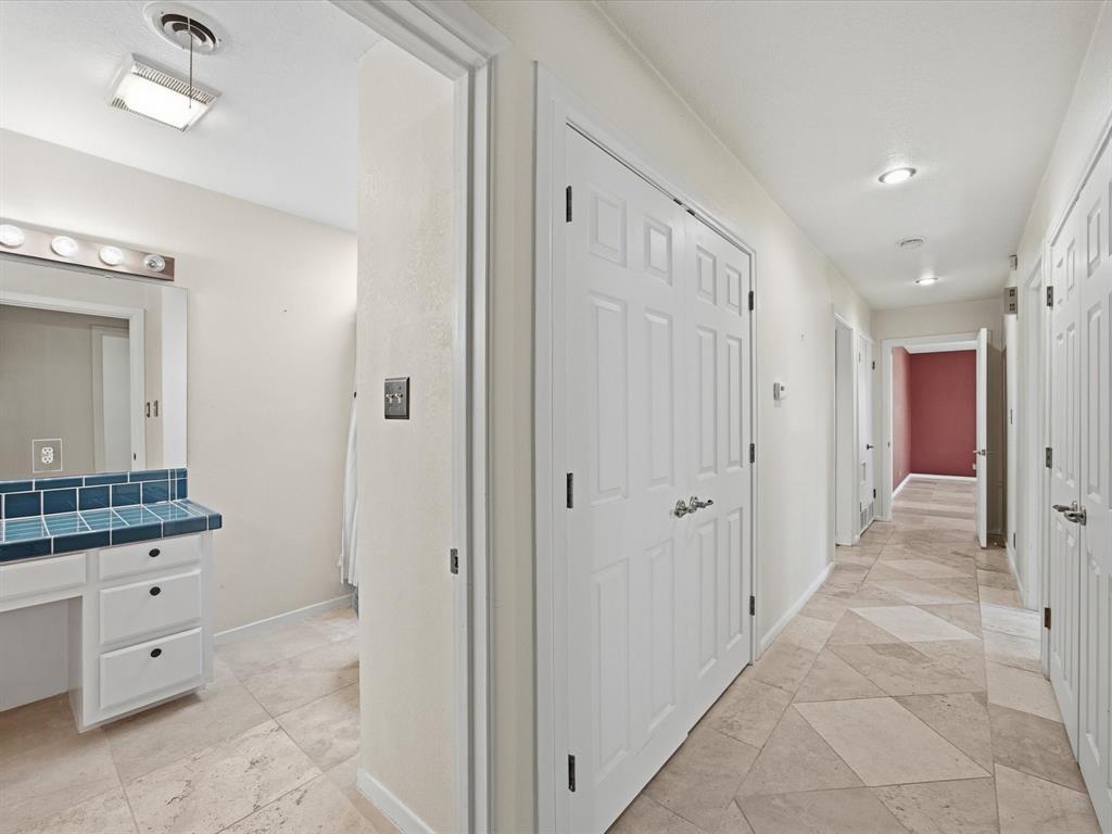 1104 Coffield Street Bowie, TX 76230 - Photo 24 of 39 a bathroom with a granite countertop sink a mirror and a shower