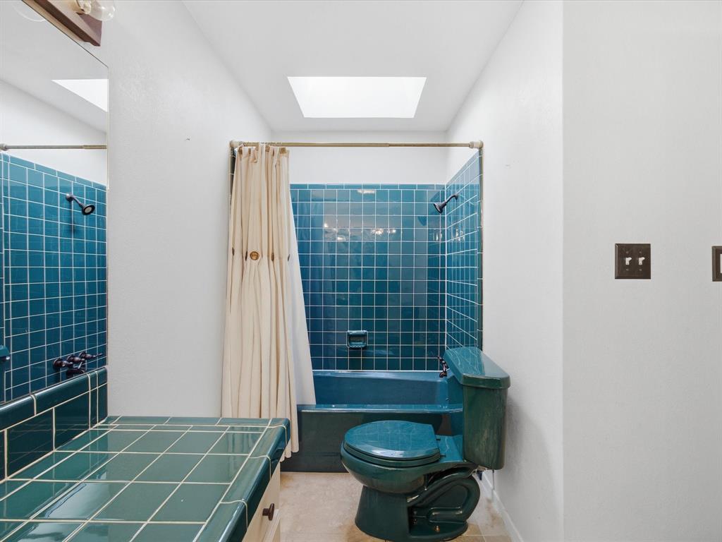 1104 Coffield Street Bowie, TX 76230 - Photo 26 of 39 a bathroom with a sink toilet and shower