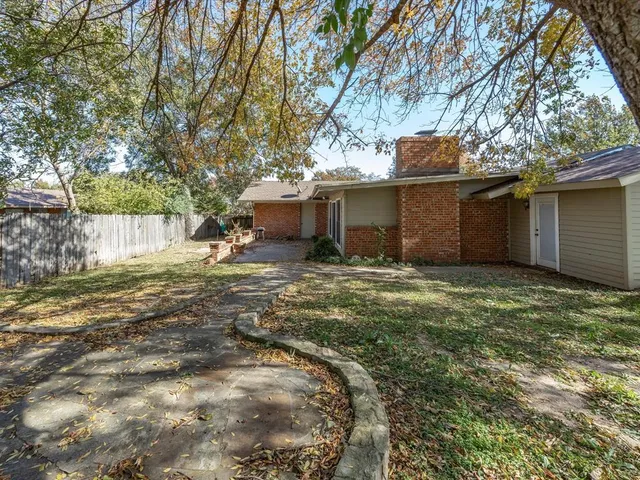 a view of a house with backyard and sitting area