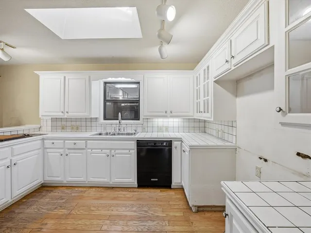 a kitchen with a sink stove and cabinets