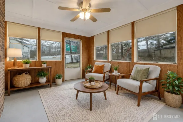 a living room with furniture and a floor to ceiling window