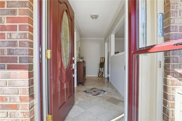 a view of a storage & utility room with refrigerator and wooden floor