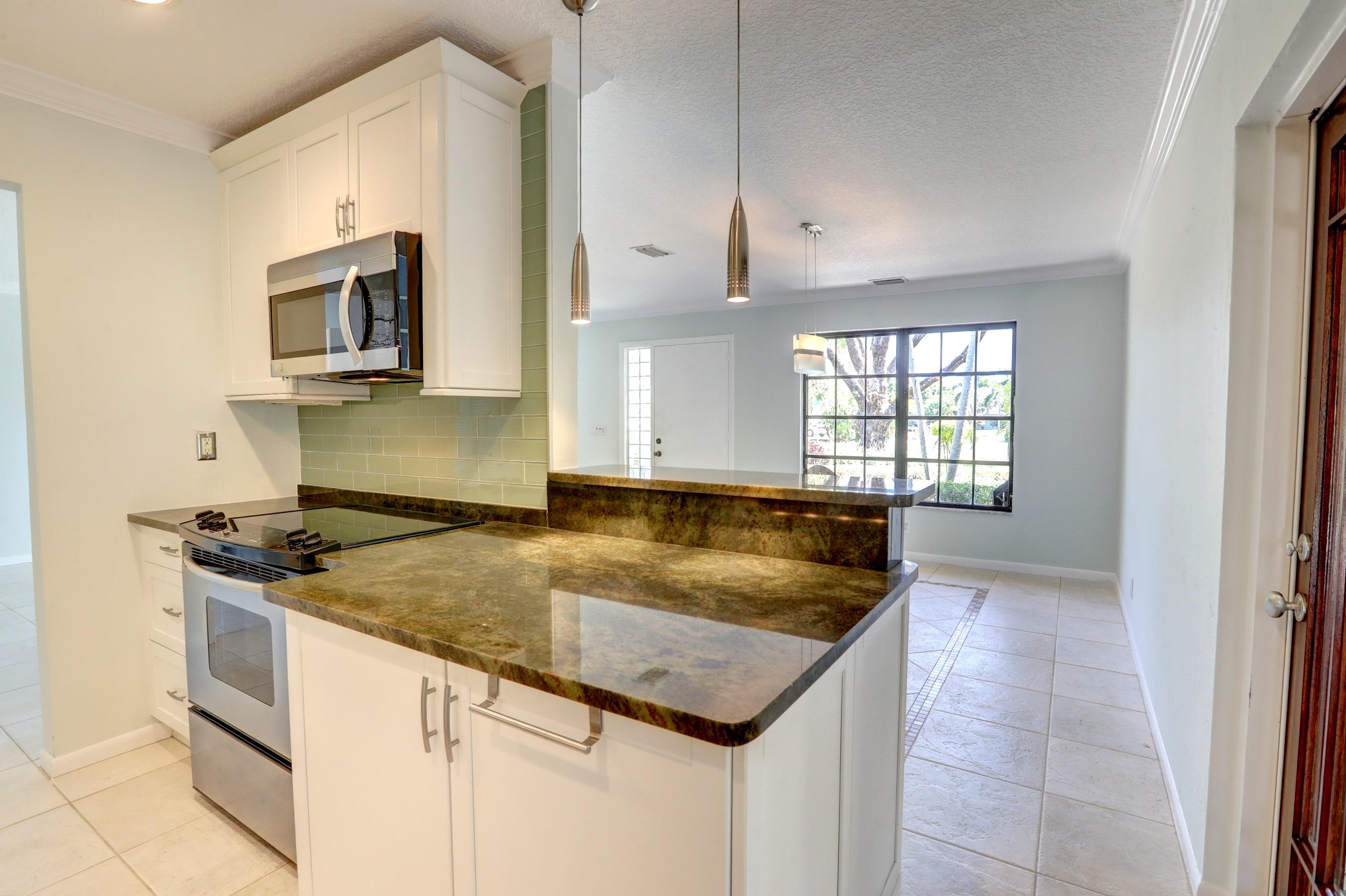 519 Curlew Road Delray Beach, FL 33444 - Photo 13 of 38 Kitchen has breakfast bar