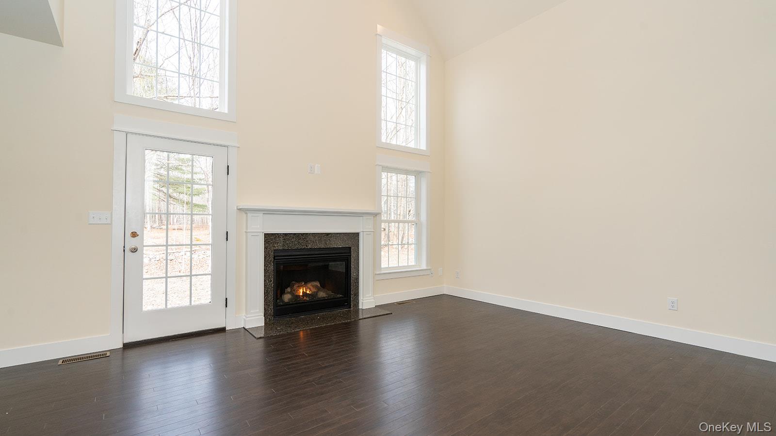 43 Malloy Road Wallkill, NY 12589 - Photo 12 of 50 Unfurnished living room with high vaulted ceiling, dark wood finished floors, a fireplace, and healthy amount of natural light