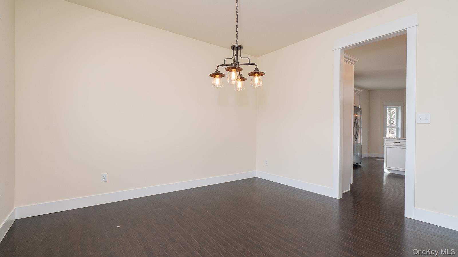 43 Malloy Road Wallkill, NY 12589 - Photo 17 of 50 Spare room with dark wood-type flooring and a chandelier