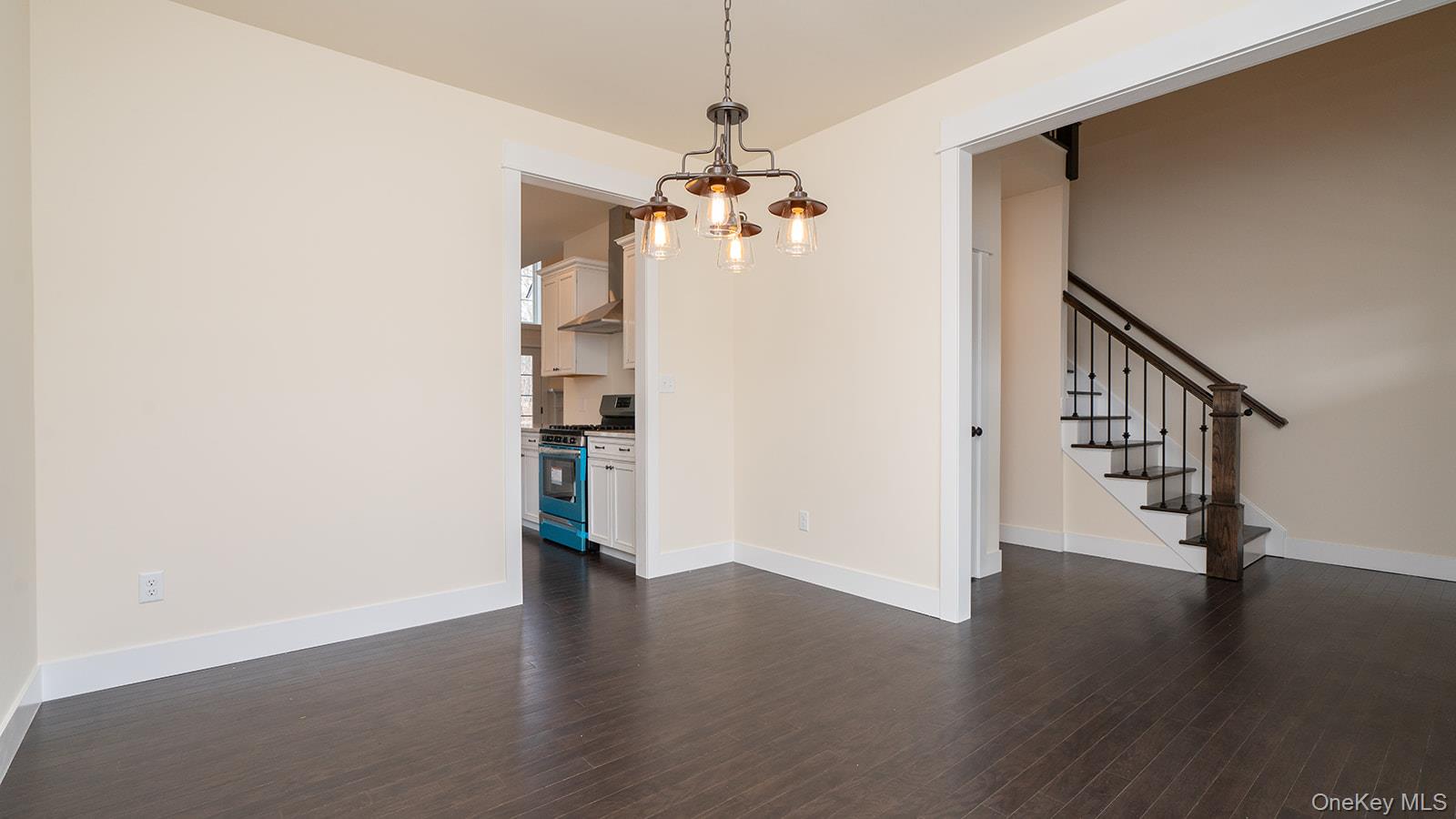 43 Malloy Road Wallkill, NY 12589 - Photo 18 of 50 Unfurnished dining area featuring dark wood finished floors, a chandelier, and stairs