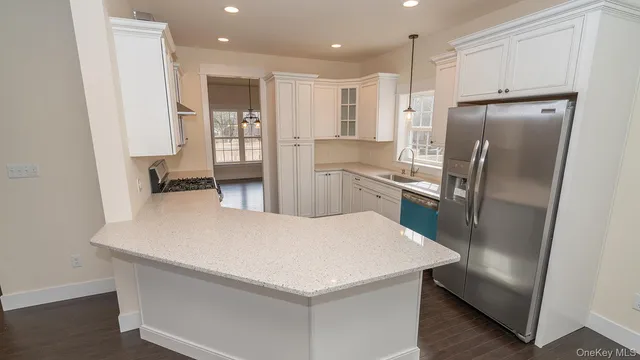 a kitchen with stainless steel appliances a refrigerator and a stove