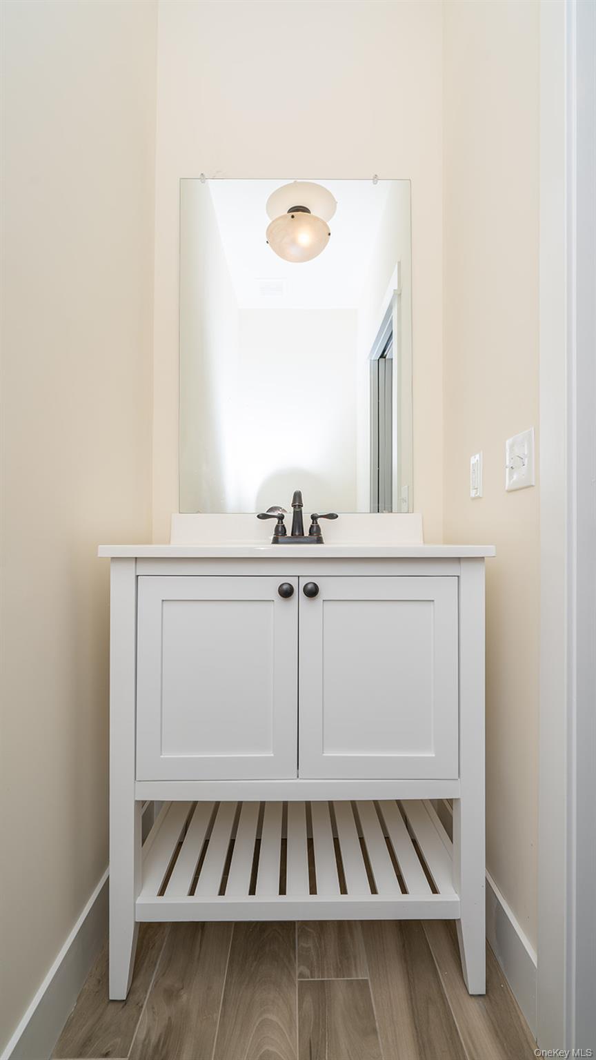43 Malloy Road Wallkill, NY 12589 - Photo 29 of 50 Half bathroom featuring vanity and light wood-type flooring
