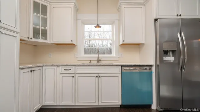 a kitchen with stainless steel appliances granite countertop a refrigerator and a sink