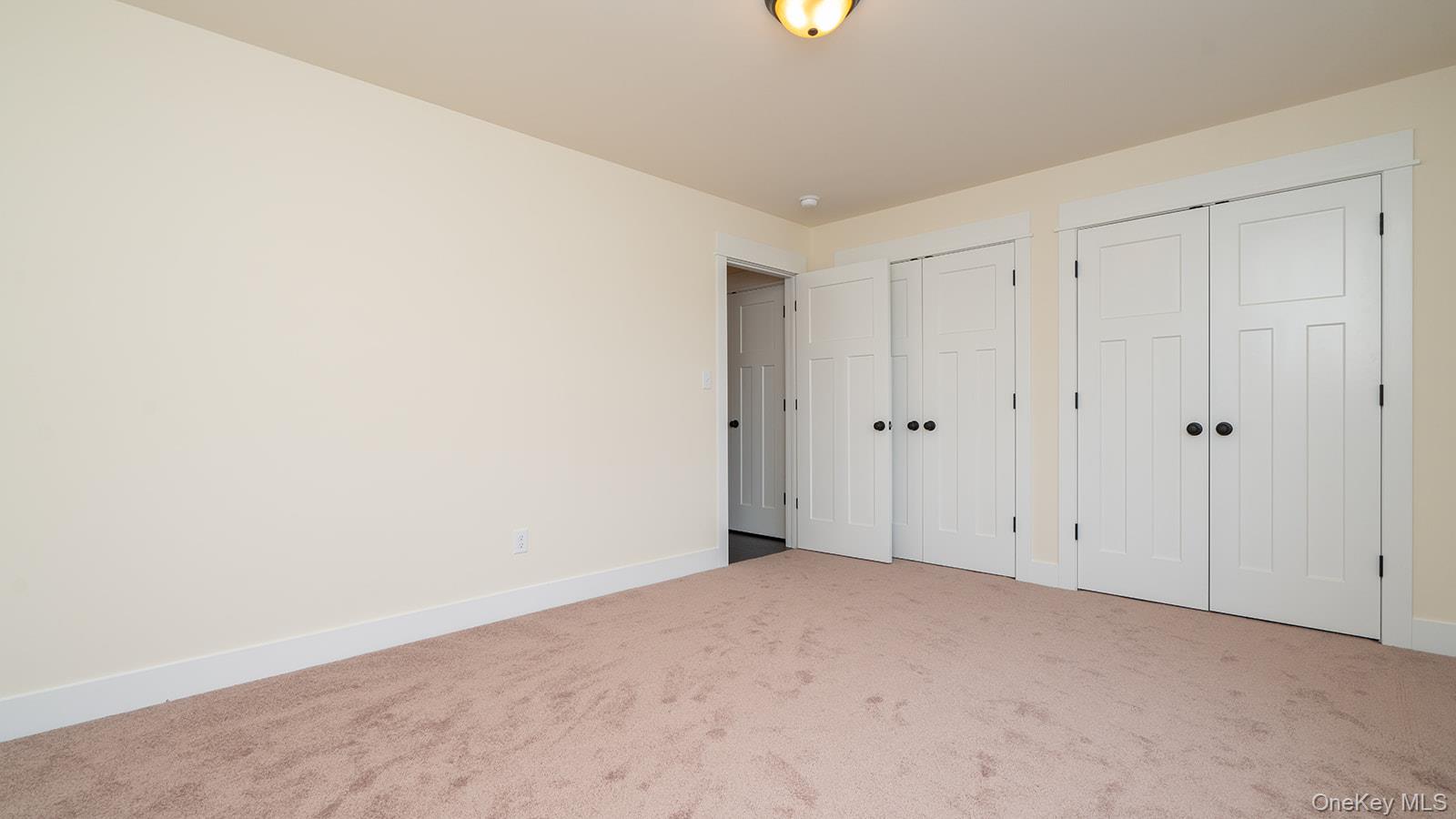 43 Malloy Road Wallkill, NY 12589 - Photo 40 of 50 Unfurnished bedroom featuring multiple closets and carpet flooring