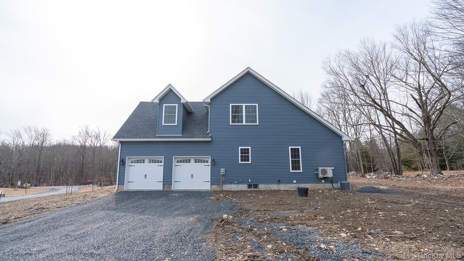 43 Malloy Road Wallkill, NY 12589 - Photo 48 of 50 View of side of home featuring driveway, a shingled roof, and a view of trees