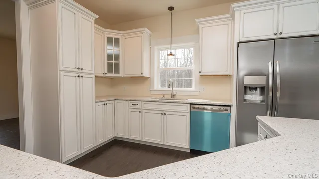 a kitchen with stainless steel appliances granite countertop a refrigerator and a sink