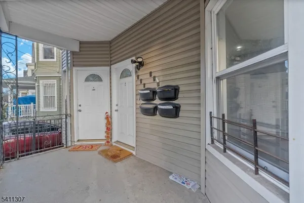 a view of a porch with a door and wooden floor