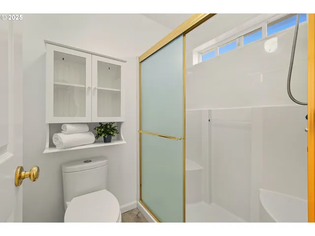 a bathroom with a shower curtain and a window