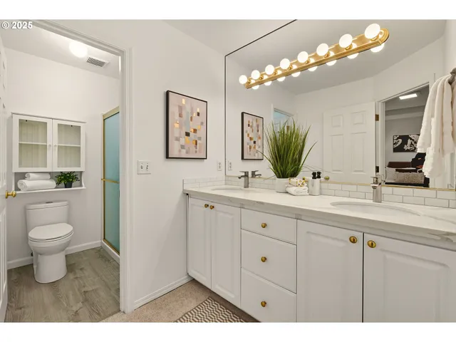 a bathroom with a toilet a sink and mirror