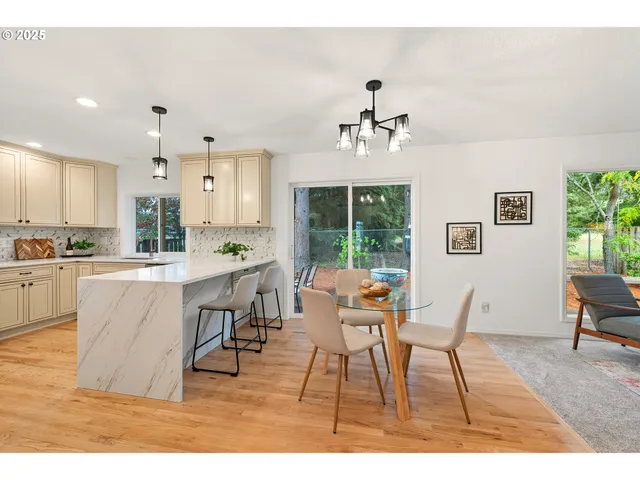 a living room with dining room and wooden floor