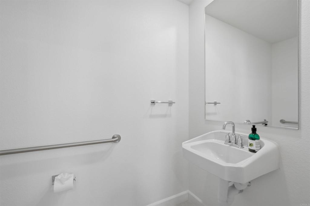 2402 Cascalote Loop San Diego, CA 92154 - Photo 26 of 35 a bathroom with a sink and a white door