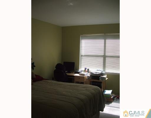 1530 Raspberry Court Edison, NJ 08817 - Photo 4 of 8 a bedroom with a bed and a window