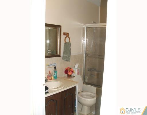 1530 Raspberry Court Edison, NJ 08817 - Photo 5 of 8 a bathroom with a sink toilet and shower