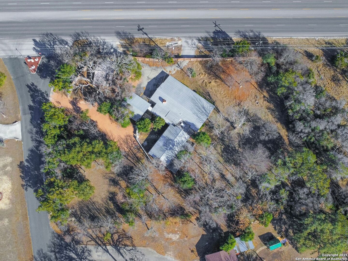 142 Royal Oaks Road Kerrville, TX 78028 - Photo 11 of 17 a view of a yard with a lot of flower plants and wooden fence