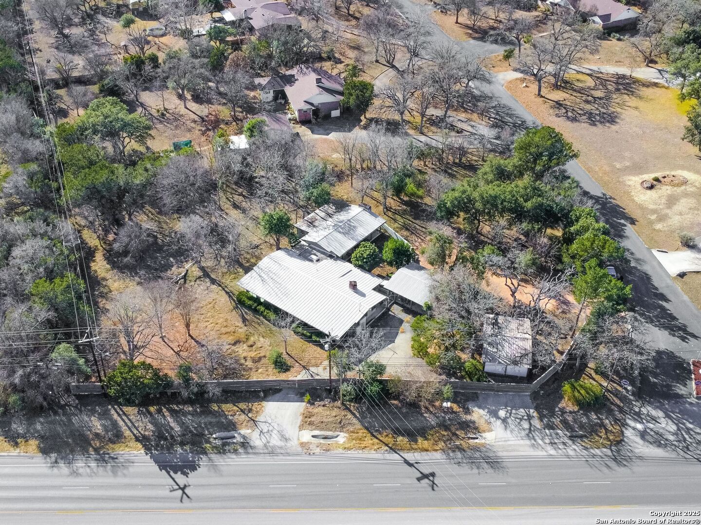 142 Royal Oaks Road Kerrville, TX 78028 - Photo 14 of 17 an aerial view of a house with a yard and parking space