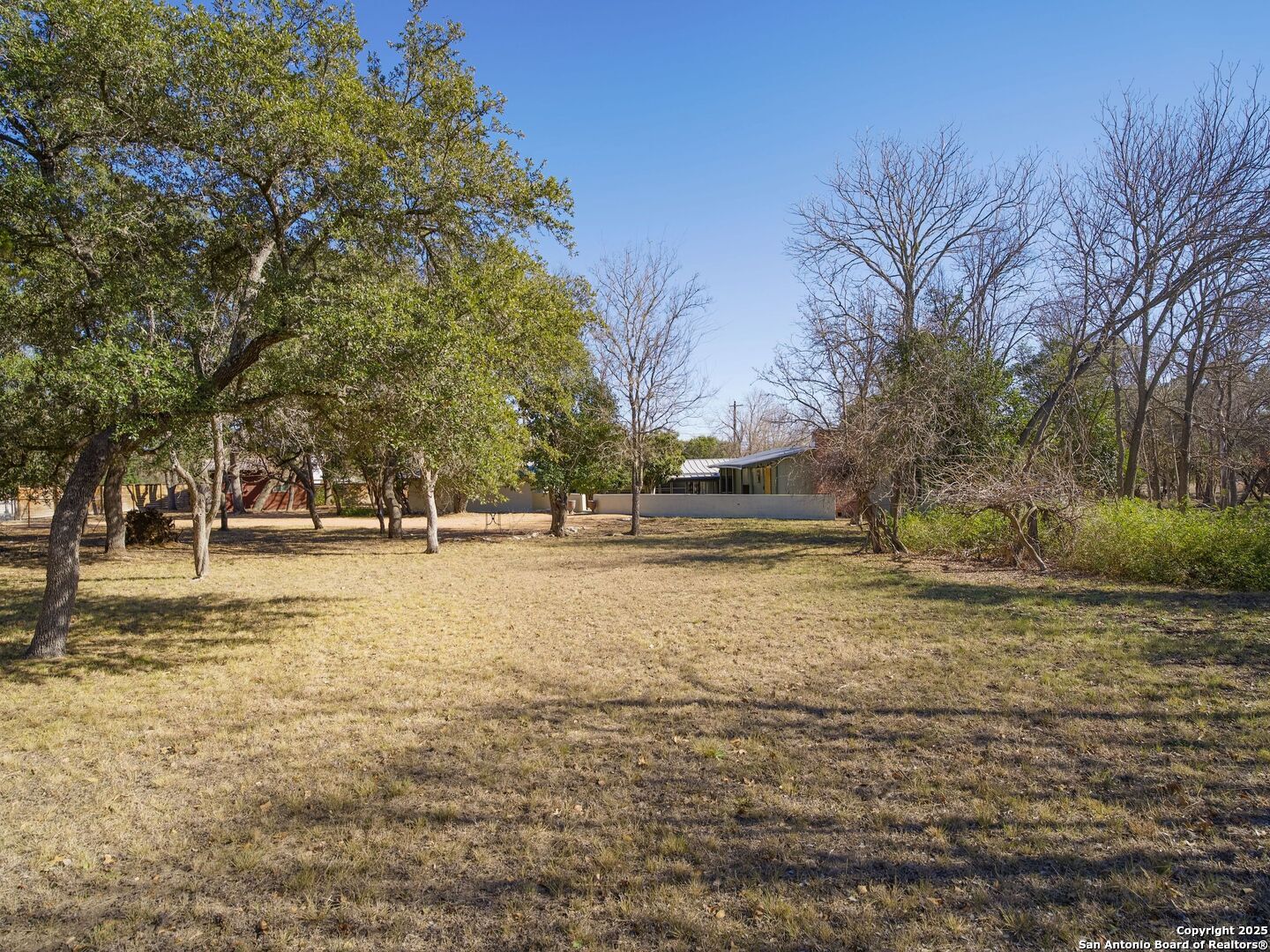 142 Royal Oaks Road Kerrville, TX 78028 - Photo 3 of 17 a view of large trees with open space