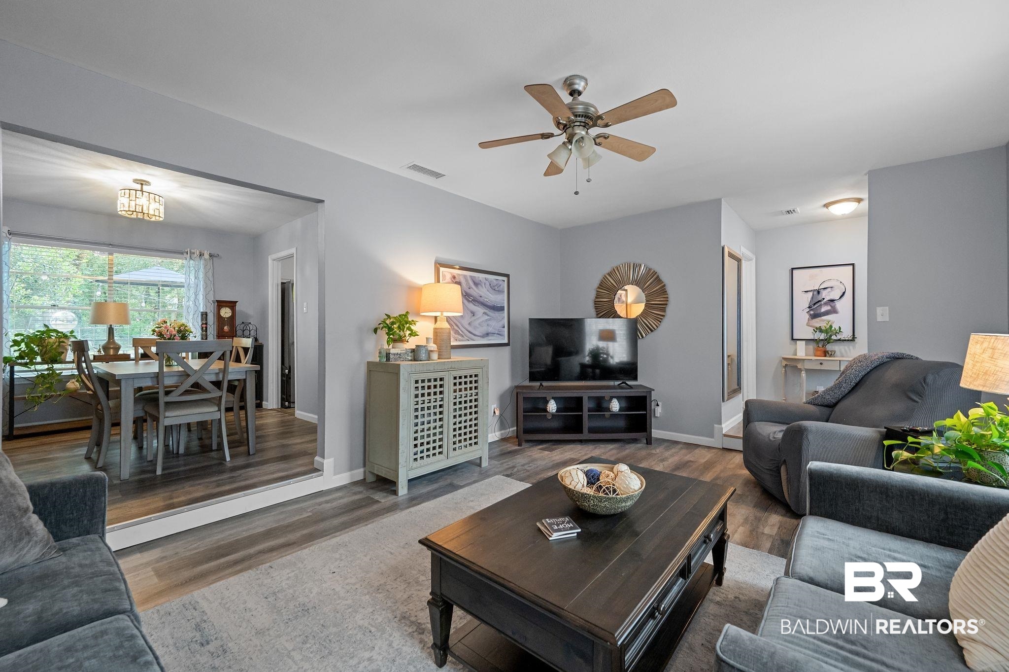 4724 Wicker Way Mobile, AL 36609 - Photo 6 of 36 Spacious living area featuring wood-finish flooring and a ceiling fan with integrated lighting