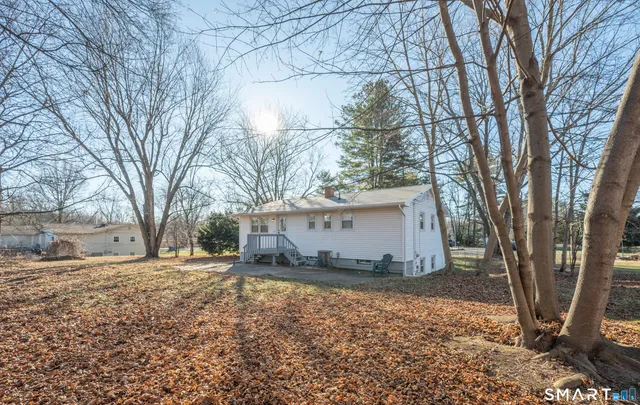 a view of white house with a large tree