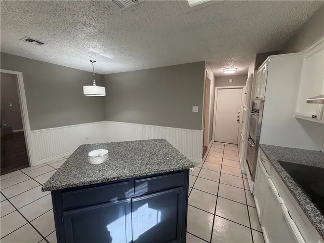 a view of a kitchen island wooden floor and staircase