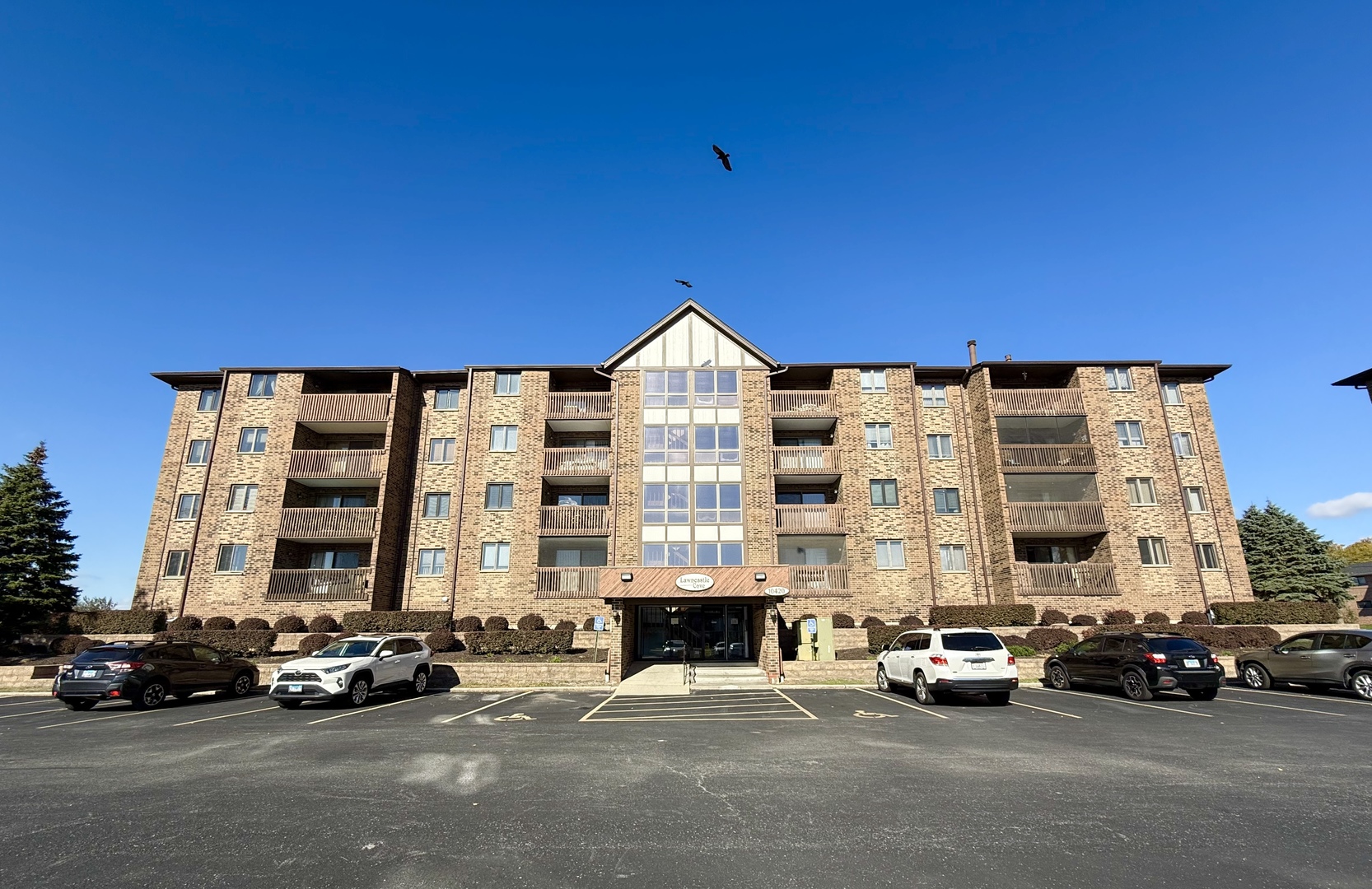 a view of a parked cars in front of a building