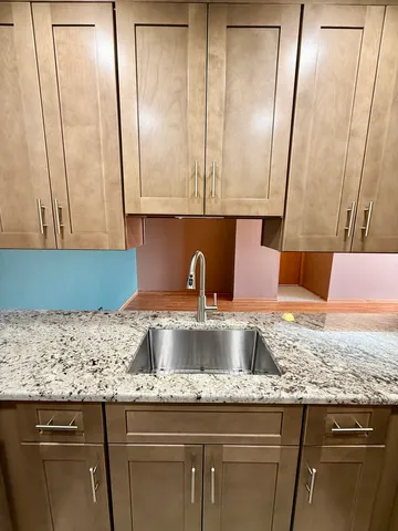 a stove top oven sitting inside of a kitchen