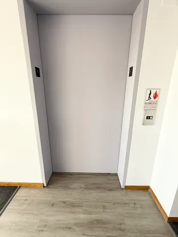 a view of utility room with hardwood floor