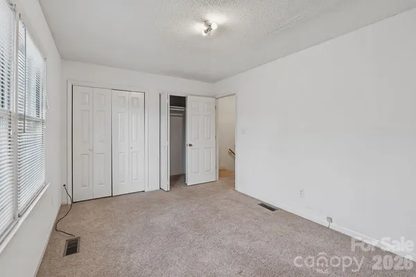 an empty room with closet area