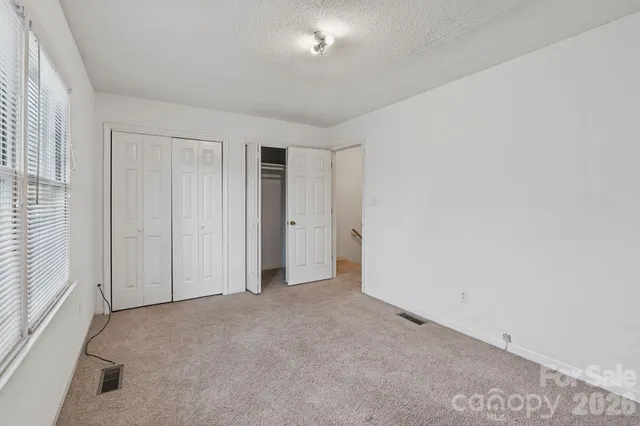 an empty room with closet area